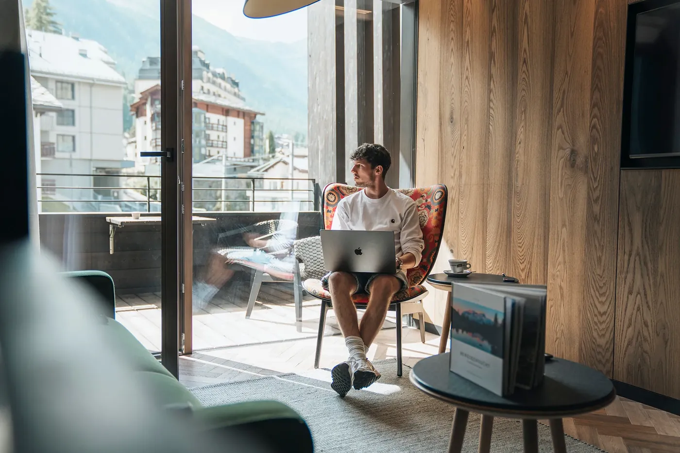 Emanuel Weber arbeitet mit dem Laptop in einer Lounge in den Bergen